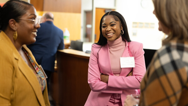 Students having a discussion in professional attire.